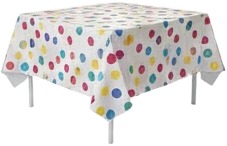 a table with a white tablecloth and colorful polka dots.jpg